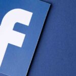 Close-up of Facebook logo on blue background